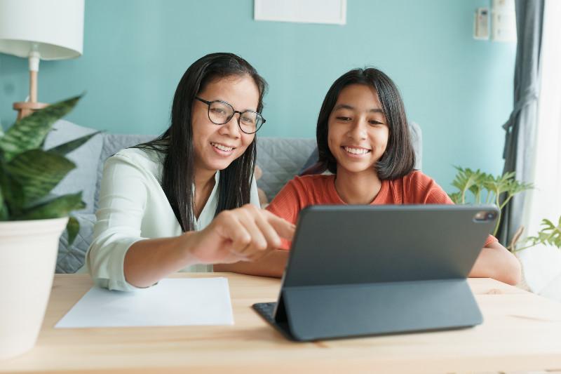 a mother and daughter at a computer