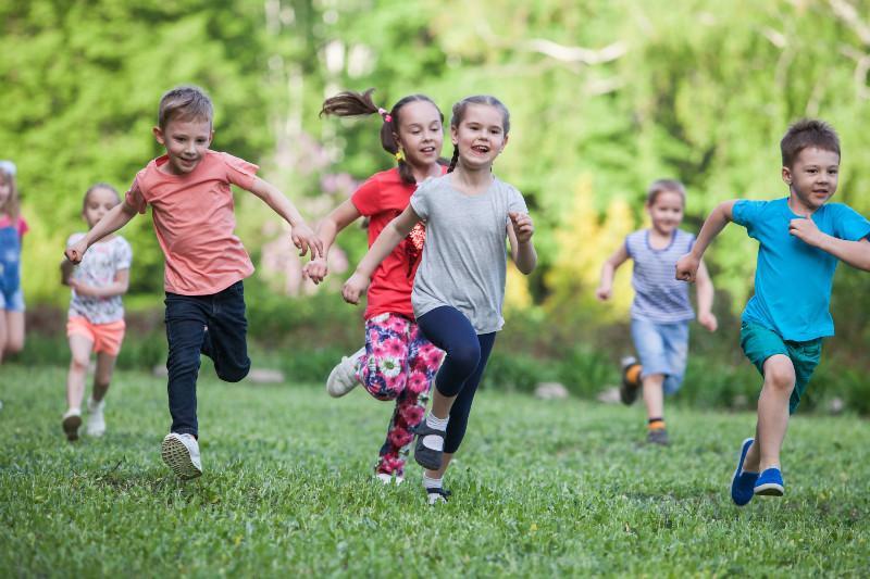 children running through a field